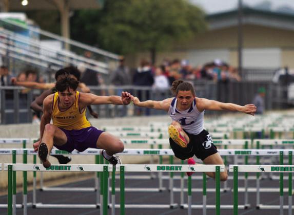 HUNTER KING | DISPATCH RECORD Asa White leaps over the final hurdle against his competition from Liberty Hill at last Thursday’s track meet in Burnet.