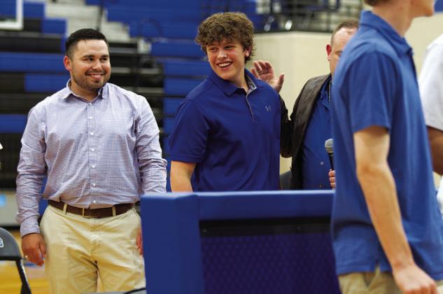 Aidan Nuckles smiles as he takes his certificate from his coach and father, Aaron Nuckles. HUNTER KING | DISPATCH RECORD