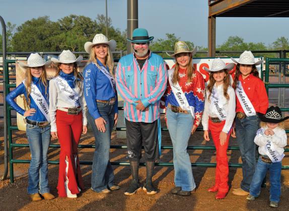 The 2024 Riata Roundup Rodeo Court, from left to right, includes Princess Allie Urich, Duchess Hadyn Ferguson, Queen Trinity Frazier standing with Riata Roundup Rodeo clown Chris Hammett, 2023 Queen Harper Evans, Sweetheart Aria Parks, Ambassador Emma Easter and Contessa Riley Thompson. erick mitchell | dispatch record