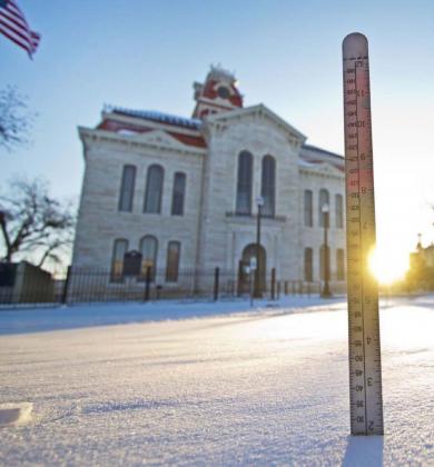 A ruler measures about two inches of snow on the courthouse square Monday morning. Downtown Lampasas was deserted much of the weekend, and high temperatures Sunday were about 40 degrees lower than average for mid-February. JEFF LOWE | DISPATCH RECORD