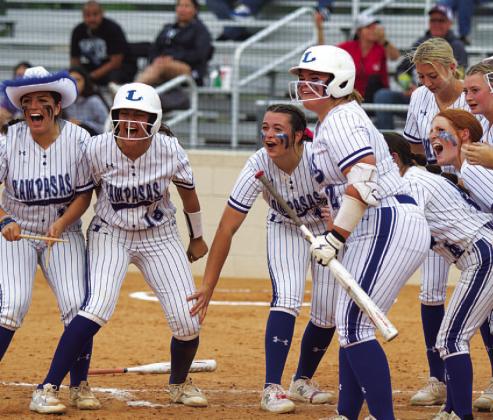 HUNTER KING | DISPATCH RECORD From left, Julia Ybarra, Madison Magilke, Brooklyn Farmer and Amari Munoz along with the rest of the Lady Badgers await Wheeler at home plate.