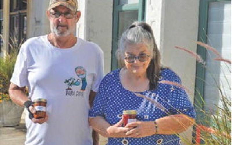 Ruth and David Somers hold up jars of their strawberry fig jam and zucchini salsa. erick mitchell | dispatch record