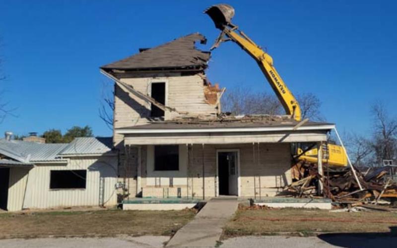 A Liberty Hill firm began work Monday to clear this house from Lometa ISD property. School officials are weighing how to use the available space once the structure is removed. MASON HINES | DISPATCH RECORD
