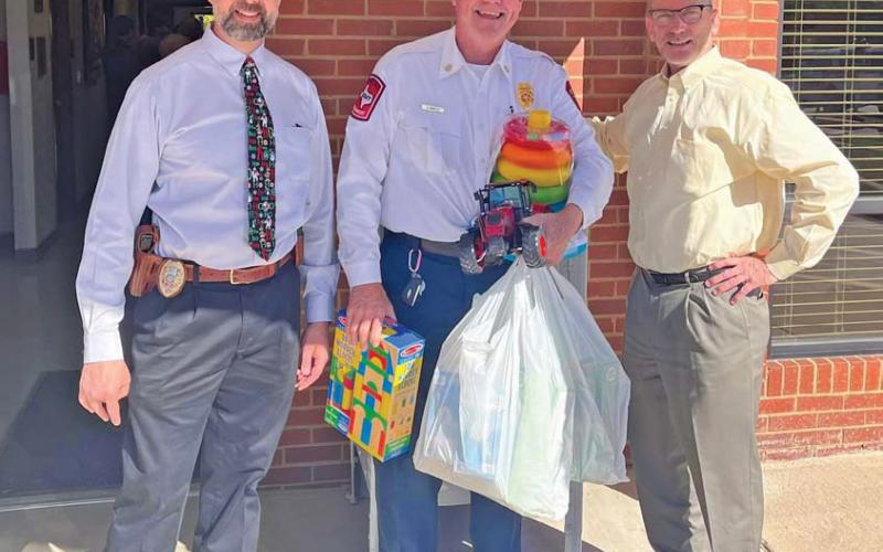 From left to right: Lampasas Police Department Chief Jody Cummings, Lampasas Fire Department Chief Jeff Smith and Lampasas City Manager Finley deGraffenried pose for a photo during the Dec. 4 luncheon event to raise funds for the Lampasas Volunteer Fire Department’s toy drive. courtesy photo | Lampasas Fire Department