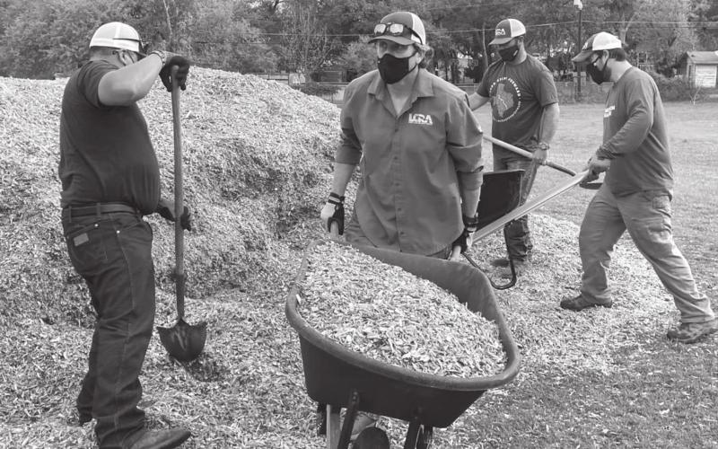 Lower Colorado River Authority employees spread mulch at W.M. Brook Park on Friday during LCRA’s Steps Forward Day. COURTESY PHOTO