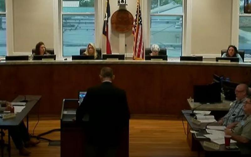 City Manager Finley deGraffenried, standing at podium, speaks to the Lampasas City Council last week about the municipal budget for Fiscal Year 2022. Presentation of a proposed budget will begin in June. SCREENSHOT FROM CITY OF LAMPASAS YOUTUBE CHANNEL
