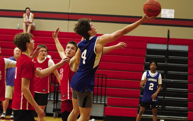 Calum Mitchell lays a ball off the glass during the Badgers’ summer league game against Salado on Wednesday. HUNTER KING | DISPATCH RECORD