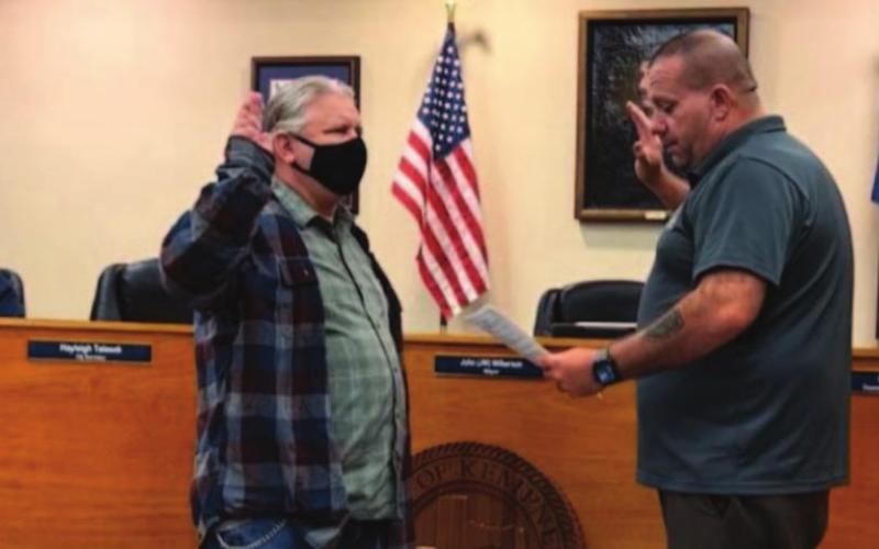 Newly appointed councilman Tom Combs, left, is sworn in by Mayor John Wilkerson Wednesday. MONIQUE BRAND | DISPATCH RECORD