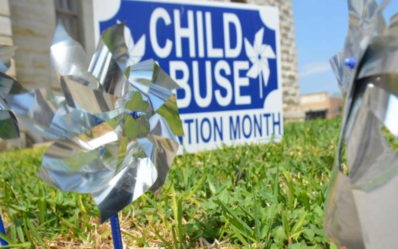 Pinwheels outside the county courthouse draw attention to National Child Abuse Prevention Month. MONIQUE BRAND | DISPATCH RECORD
