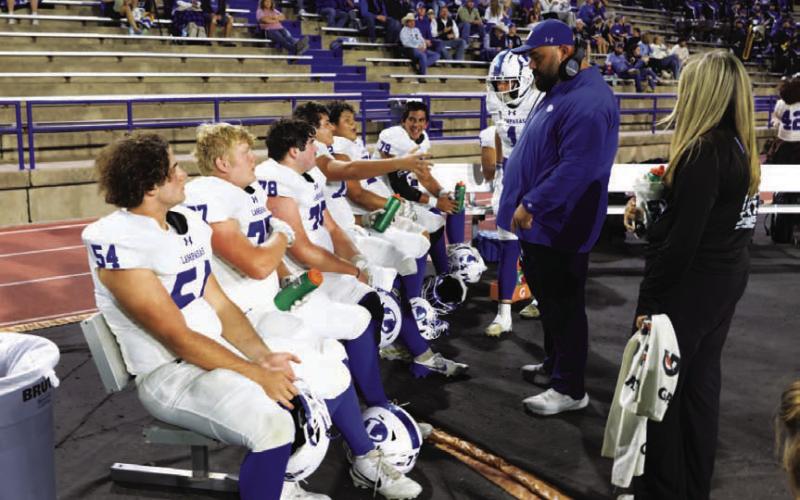 COURTESY PHOTO | MICHAEL KUEHNE TJ Cleavinger talks with his offensive line between series.