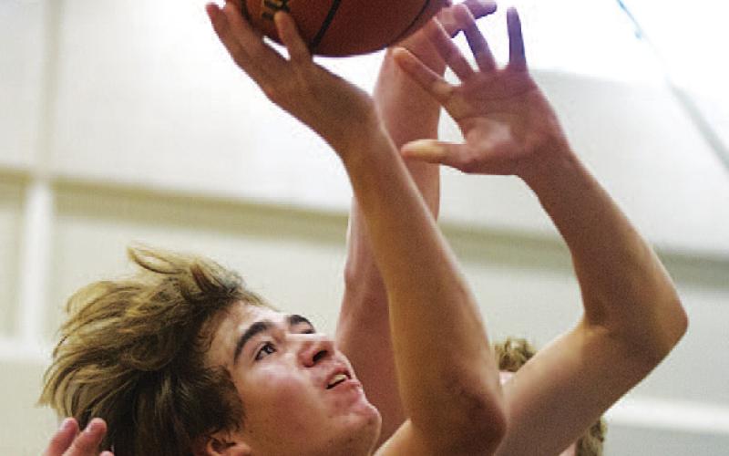 HUNTER KING | DISPATCH RECORD Jax Pratus finishes a layup through contact during Tuesday’s game against Richland Springs.