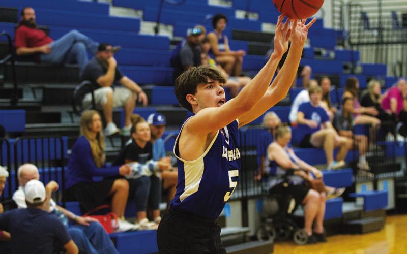 HUNTER KING | DISPATCH RECORD Micah Papke releases a three-point shot from the corner.