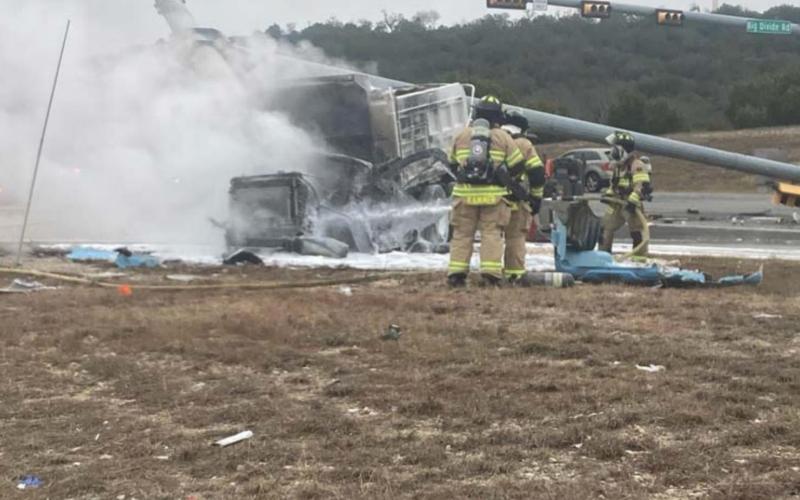 Copperas Cove firefighters extinguish flames from a gravel truck involved in a two-vehicle collision Tuesday morning near Big Divide Road. MONIQUE BRAND | DISPATCH RECORD