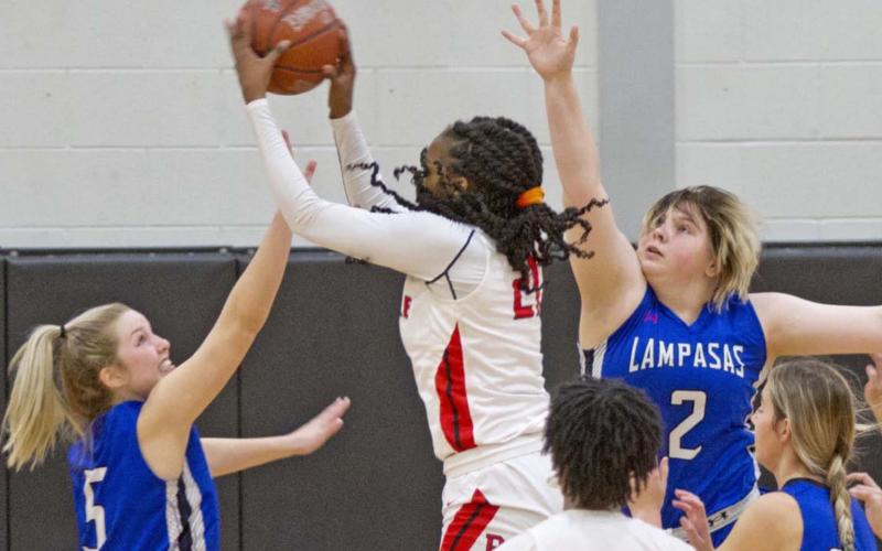 Laurcy Bender (5), Morgan Lovejoy (2) and Payton Tatum (far right) defend against Texas A&amp;amp;M signee Eriny Kindred in a 64-32 win over Del Valle on Friday. JEFF LOWE | DISPATCH RECORD