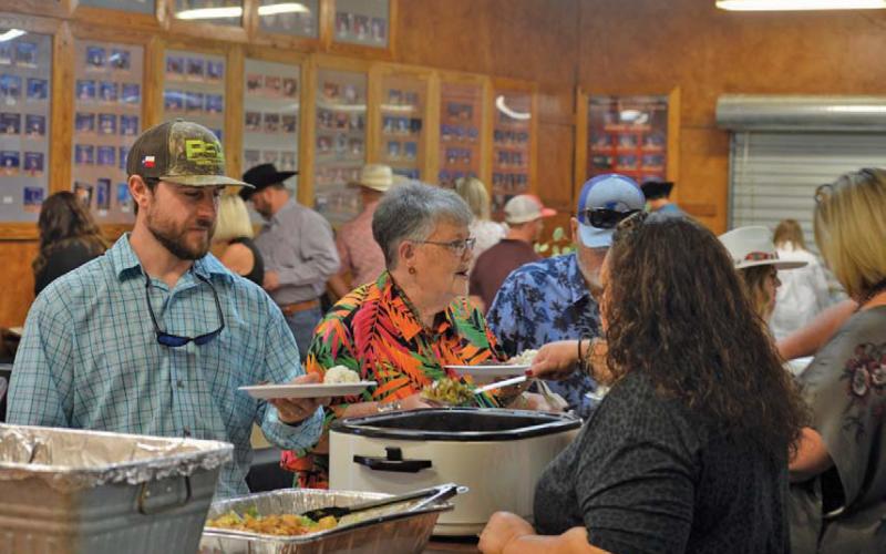 Lampasas County Livestock Association Reverse Raffle attendees stand in line to receive their food during Saturday’s event festivities. erick mitchell | dispatch record