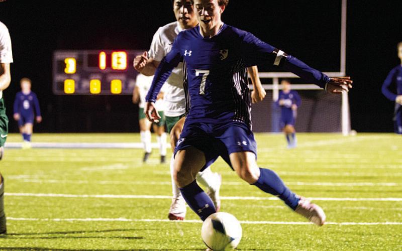HUNTER KING | DISPATCH RECORD Cooper Pfaltzgraff shoots with his left foot to score against Academy last Friday night.