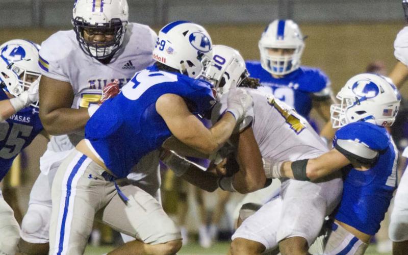 On fourth down, Ian McKinney (99) and Case Brister (far right) tackle one of the state’s top quarterbacks, Andrew Body, to give the Badgers one last offensive drive as they attempt a 19-point comeback. JEFF LOWE | DISPATCH RECORD