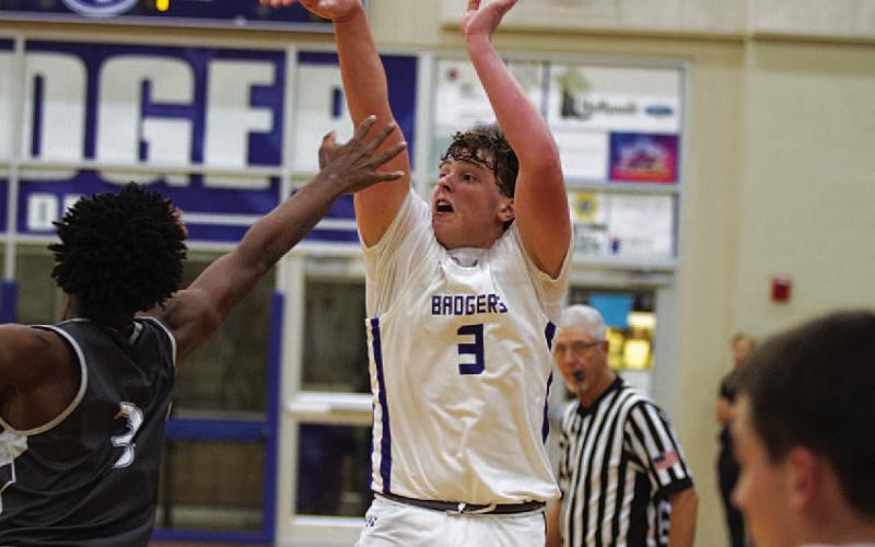 HUNTER KING | DISPATCH RECORD Aidan Nuckles shoots over an outstretched hand to knock down one of his three long-range shots during the season opener.