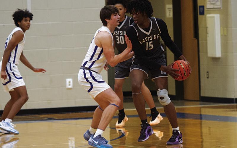 HUNTER KING | DISPATCH RECORD Calum Mitchell defends an Eastside player during Tuesday’s game. The junior pulled down seven rebounds in the game as well.