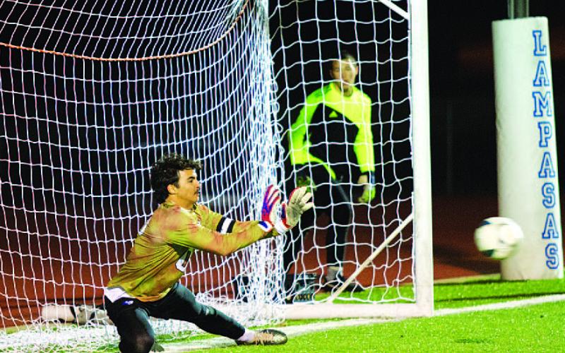 HUNTER KING | DISPATCH RECORD Michael Clayton dives to save a penalty kick against the Brownwood Lions last Friday night.