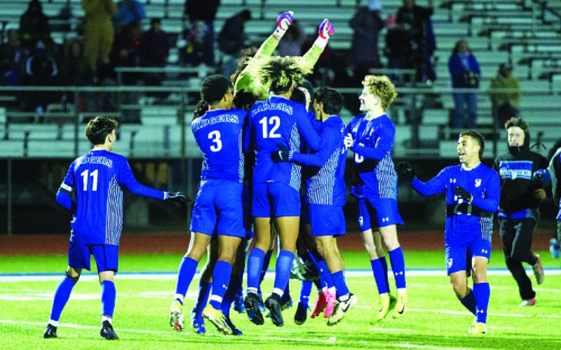 The Badgers celebrate their win in freezing cold temperatures. HUNTER KING | DISPATCH RECORD