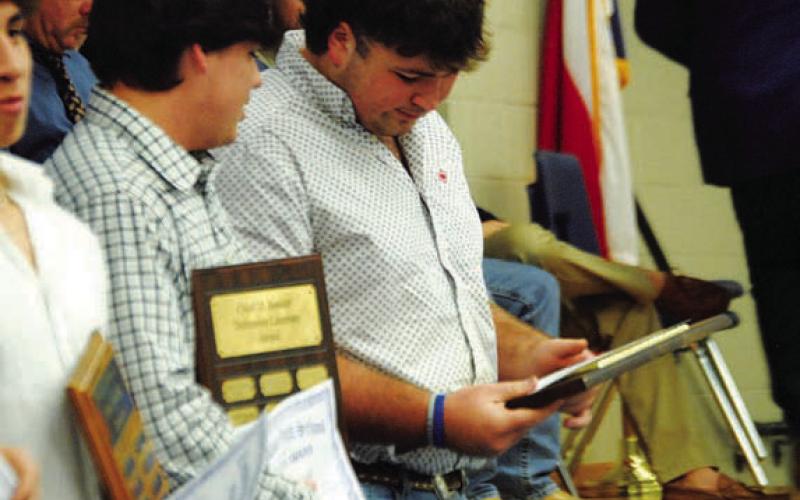 Shea Robinson looks over his award on Monday night. HUNTER KING | DISPATCH RECORD
