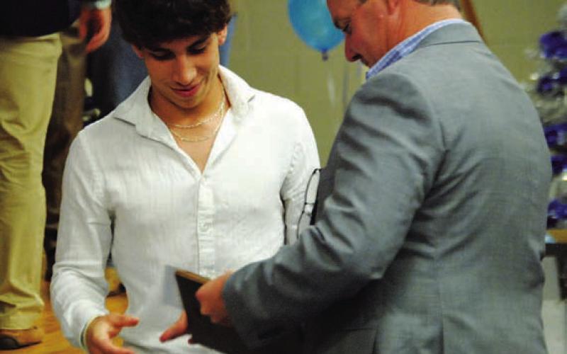 Ethan Moreno is handed his award by Rogers. HUNTER KING | DISPATCH RECORD