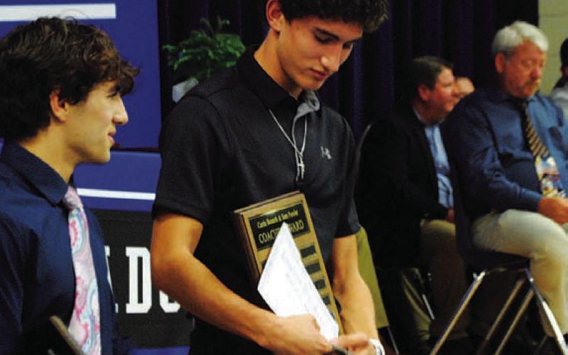 Ayden Shaw holds onto his Coaches’ Award for the 2022 season. HUNTER KING | DISPATCH RECORD