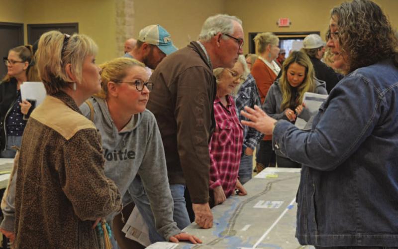 Tamara Hamm, at left, and Debra Shutts speak with TxDOT officials concerning the proposed U.S. Highway 281 Lampasas-to-Evant expansion project. ERICK MITCHELL | DISPATCH RECORD