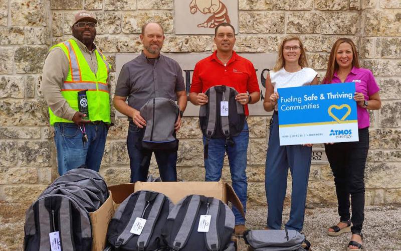Atmos Energy makes backpack donations to local schools