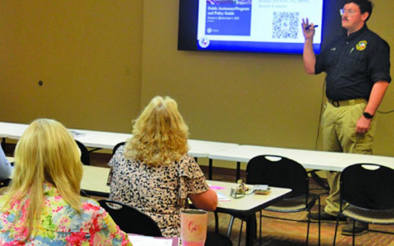 TDEM Regional Recovery Coordinator Matthew Weeks provides a presentation to the Lampasas County Commissioners Court and representatives of other local entities to outline the availability of FEMA public assistance to cover May’s flooding events. ERICK MITCHELL | DISPATCH RECORD