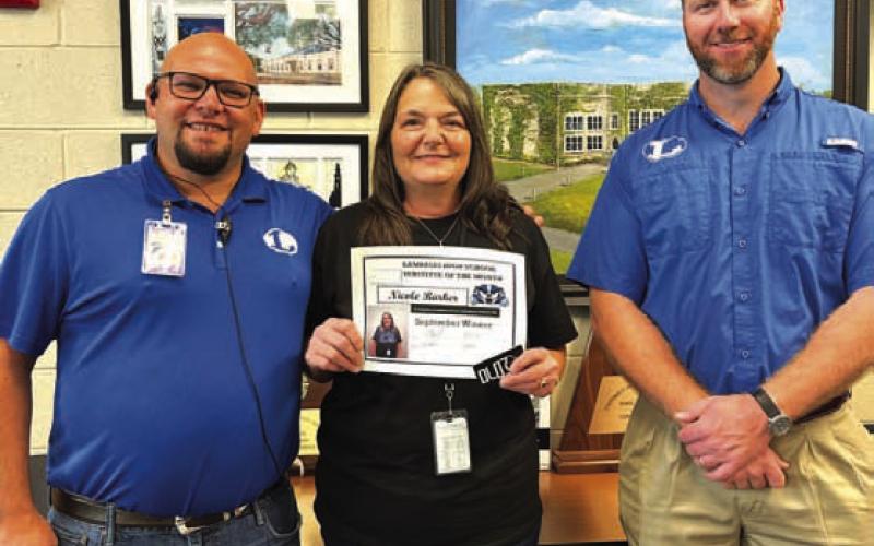 COURTESY PHOTO LHS Assistant Principal Ryan Race, at left, presents Nicole Barker with a certificate recognizing her as Substitute of the Month for September. Clay Phillips of Texas Farm Bureau Insurance also extended his appreciation to Barker for her work at the high school campus.