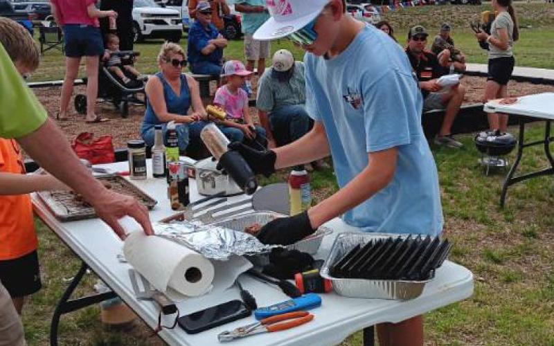 Kid’s Que competitors prep their entries at the LTX BBQ event. Youth participants were eligible for points and prizes at this year’s competition. COURTESY PHOTO