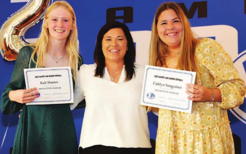 Kali Hunter, left, and Caitlyn Sanguinet, right, smile with their head coach at the banquet. CHRIS MILES | COURTESY PHOTO