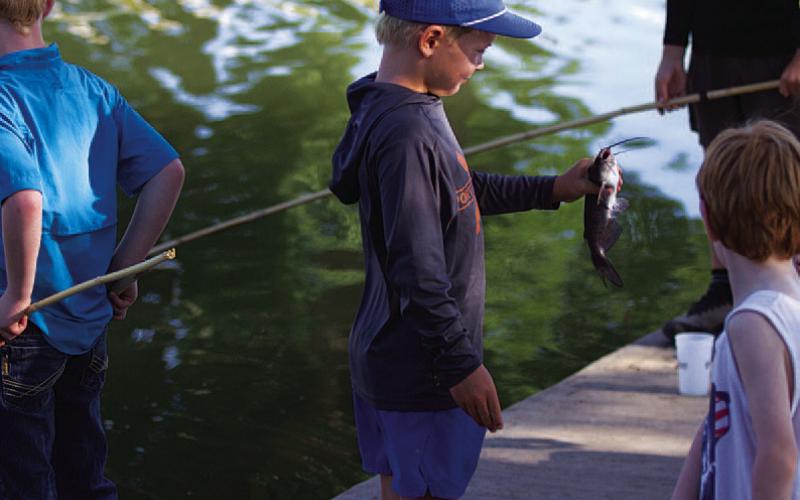 HUNTER KING | DISPATCH RECORD Bear Orlando shows off a catfish he caught on Wednesday.
