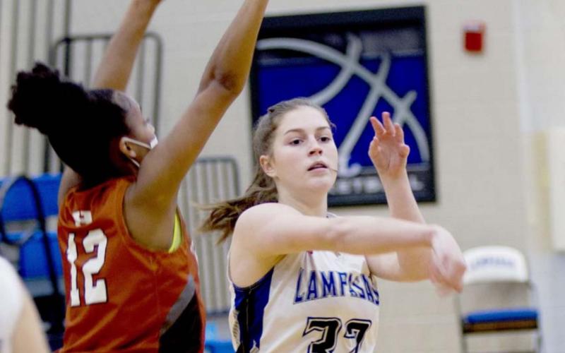 Freshman point guard Kenzie Roberts passes the ball in the varsity game on Saturday. JEFF LOWE | DISPATCH RECORD