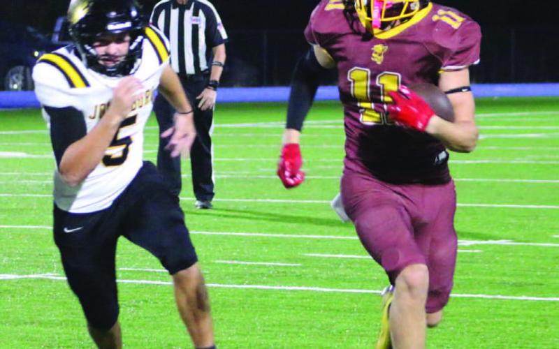 Stone Carr-Jones finds space around the edge while running for a score on Friday. MASON HINES | DISPATCH RECORD