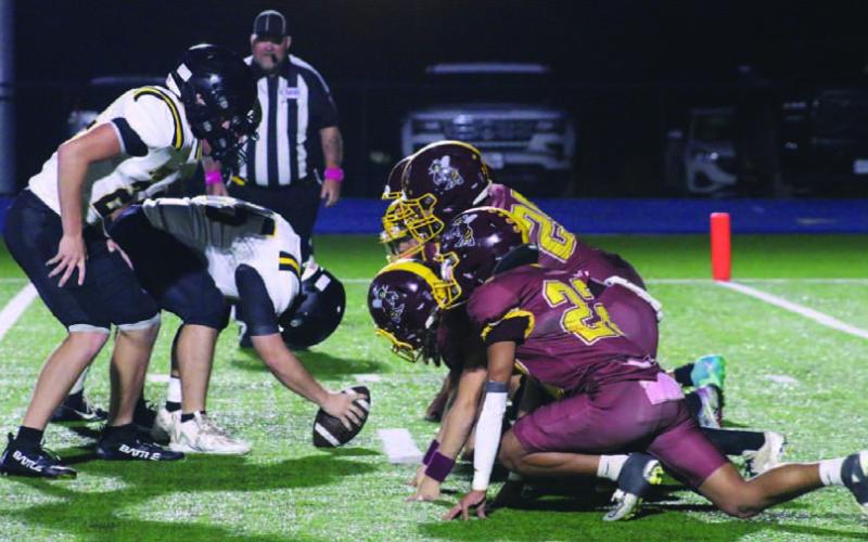 Hornet players locked in during an extra-point block during the loss to Jonesboro. MASON HINES | DISPATCH RECORD