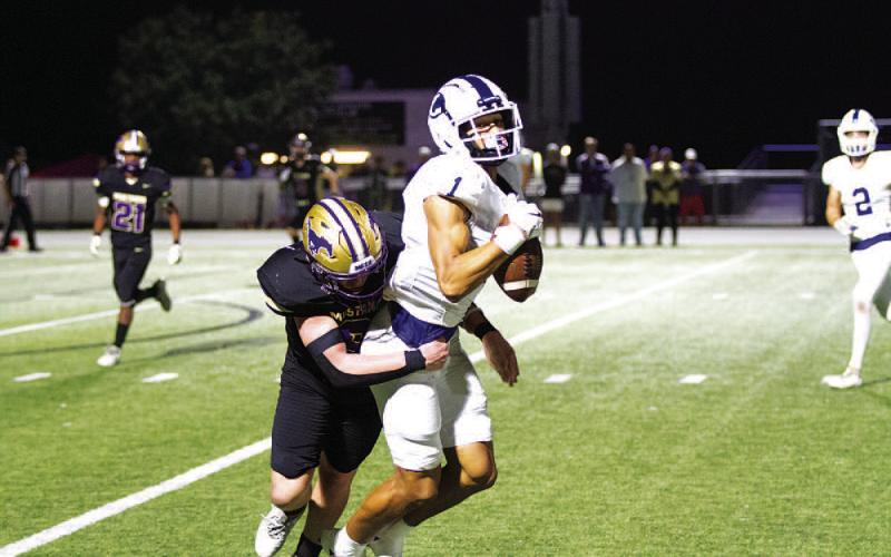 Ty Johnson makes a catch while getting hit against Marble Falls in the regular-season finale. HUNTER KING | DISPATCH RECORD