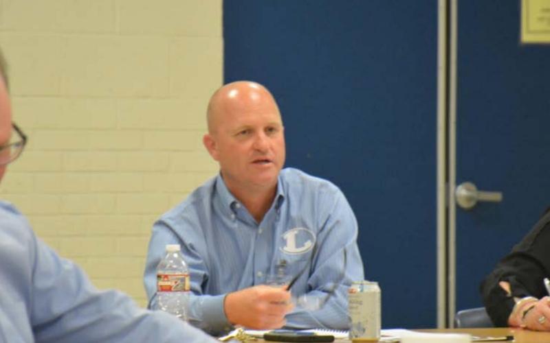 Chief Financial Officer Shane Jones, center, goes over summer school plans as board member Rob Borchardt, left, listens in and Secretary to Superintendents Joni Summers writes notes. MONIQUE BRAND | DISPATCH RECORD