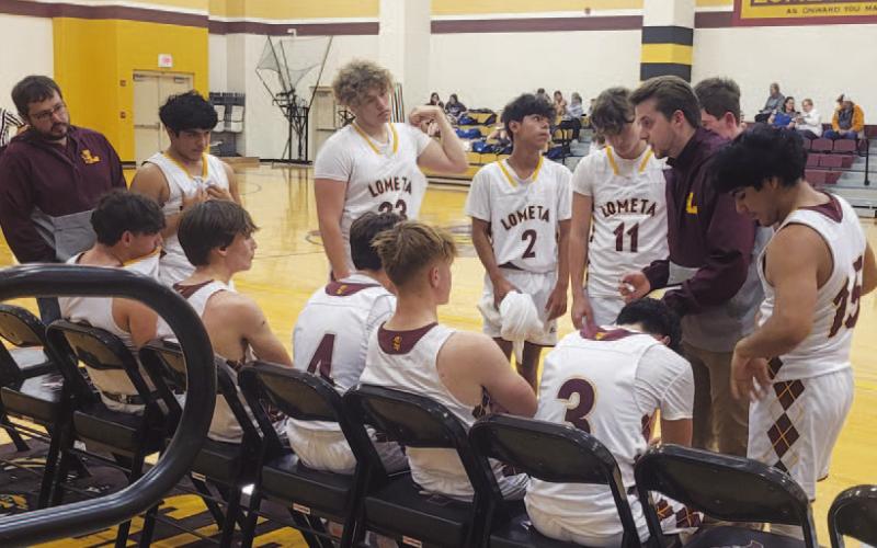 COURTESY PHOTO | CHERI WIENECKE Lometa boys’ basketball head coach Austin Martin draws a play during Lometa’s tournament game against Rising Star on Friday. The Hornets fell to Rising Star 66-53 in a physical and fast-paced game.