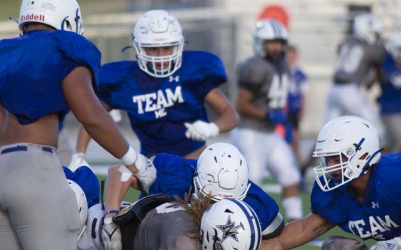 A group of Badgers is in on the tackle of a Navasota ball carrier during the live quarter of the scrimmage. HUNTER KING | DISPATCH RECORD