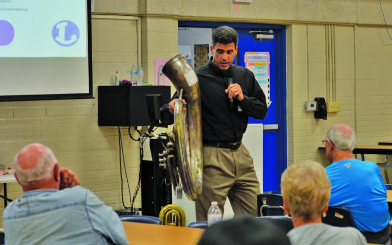 Superintendent Dr. Chane Rascoe holds up a worn-out tuba to illustrate the band’s need for new instruments. With an auditorium off the table, the school district hopes to include $1 million for fine arts upgrades in a 2026 bond. ERICK MITCHELL | DISPATCH RECORD