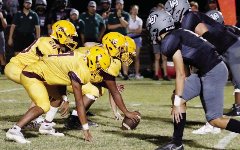 MASON HINES | DISPATCH RECORD The Hornets line up against Waco Live Oak during last week’s game. Lucas Smailus Cruz (22) runs the ball during Lometa’s loss Friday.