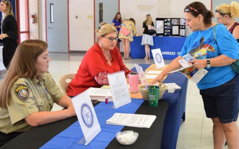 Cristopher Brister and Rebecca Ramos, seated from left to right, represent Lampasas County as Carrie Kirk, second from right, and her daughter Hannah interact with the public-sector employer during the Lampasas Economic Development Corp.’s 2019 job fair. The 2020 job fair was canceled due to the coronavirus, but the LEDC will hold this year’s event Thursday from 10 a.m. to 2 p.m. at the Lampasas County Higher Education Center. FILE PHOTO