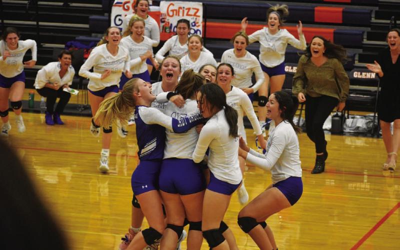 The volleyball team bursts into celebration after winning their play-in game to make the playoffs. FILE PHOTO