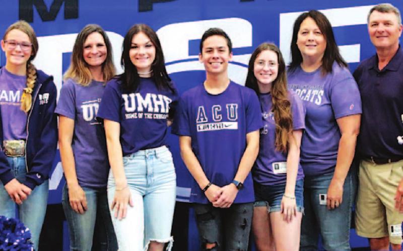 April Smith, left center, and Sam Zmolik, right center, pose with their families. CHRIS MILES | COURTESY PHOTO