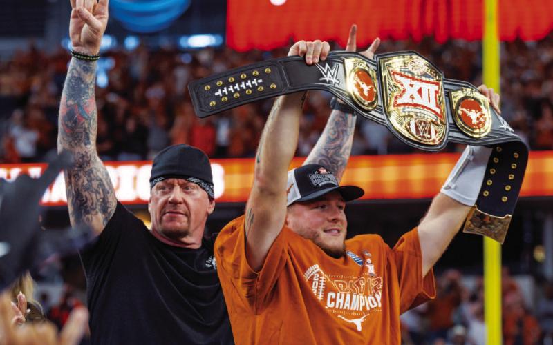 Quinn Ewers, right, poses with the MVP belt from the Big 12 Championship. Standing next to Ewers is professional wrestler, Undertaker. COURTESY PHOTO | TEXAS ATHLETICS