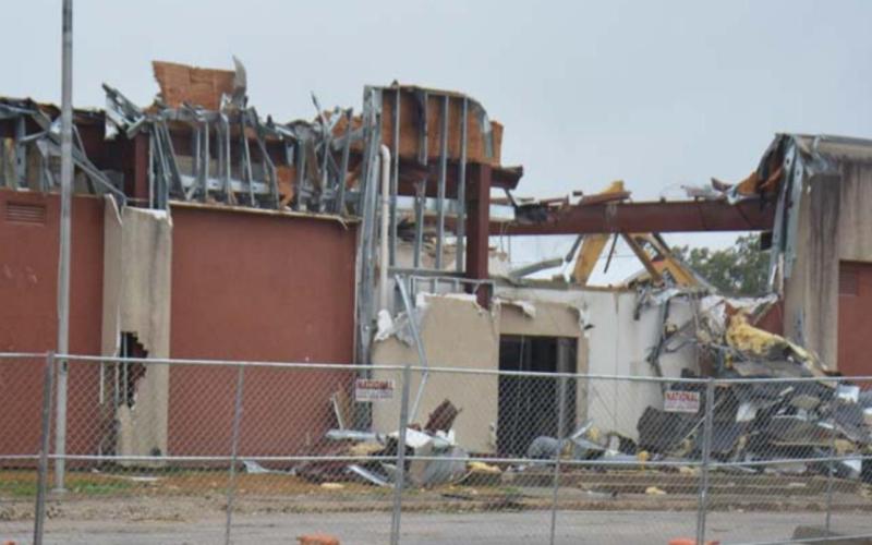 The Alamo 1 Environmental crew continues to dismantle the former Lampasas County Jail on East Fourth Street in this photo taken Monday morning. MONIQUE BRAND | DISPATCH RECORD