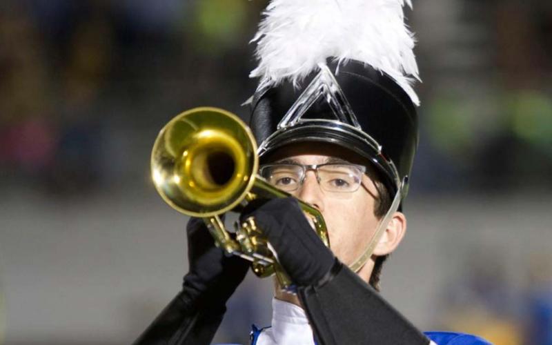 Senior Travis Calk is among the upperclassmen in the Badger Band. He is shown here playing the trumpet during a halftime performance of “The Witching Hour.” hunter king | Dispatch Record